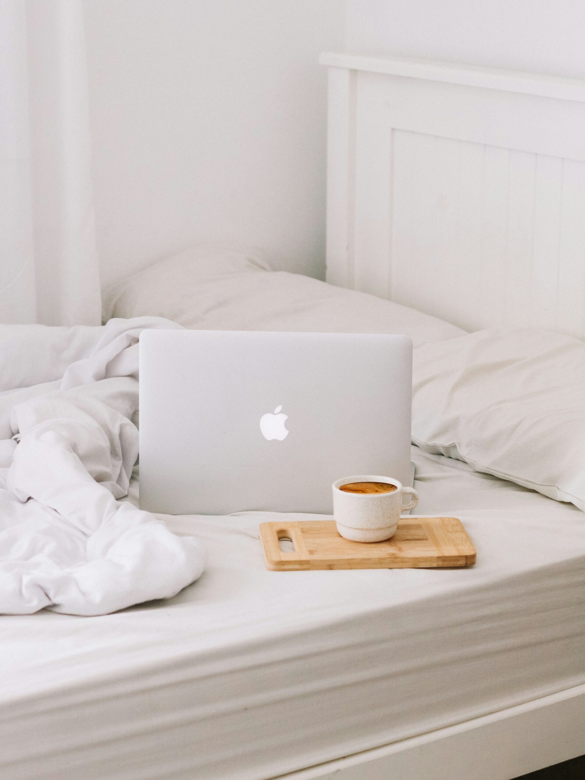 laptop on top of a cozy bed.